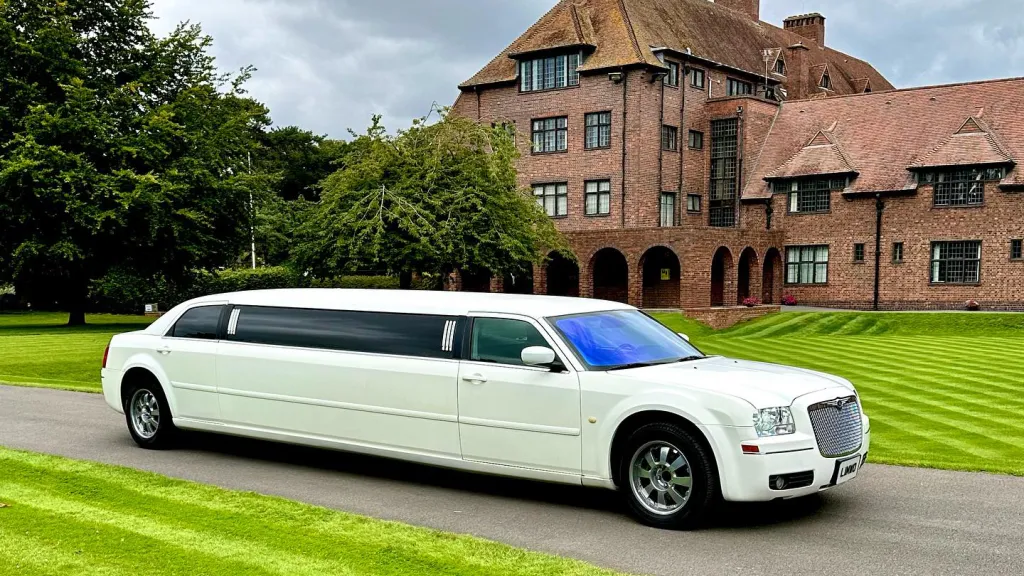 White Stretched Limousine in front of a wedding venue