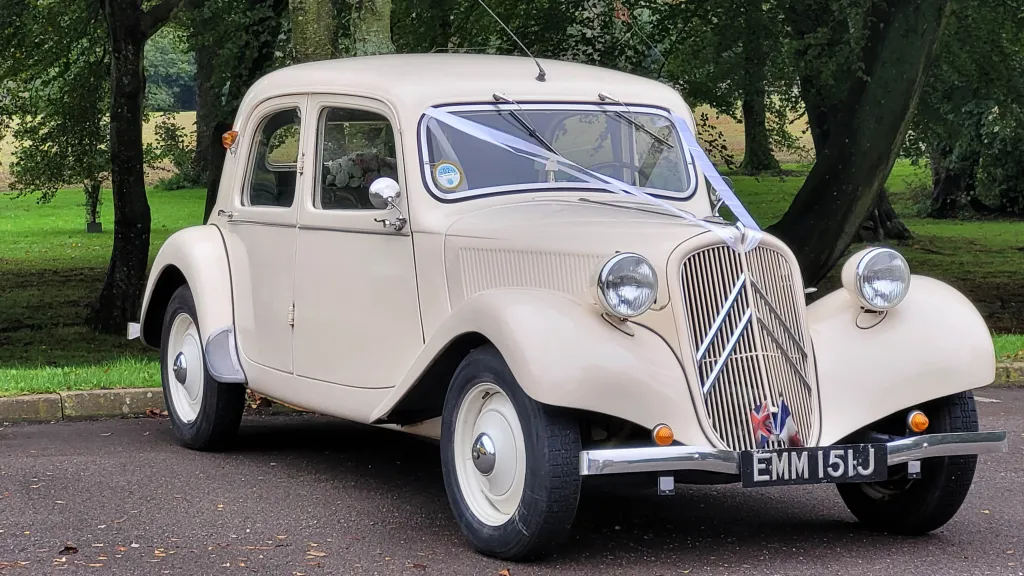Traditional Ivory Citroen Wedding Car for Hire dressed with white ribbons