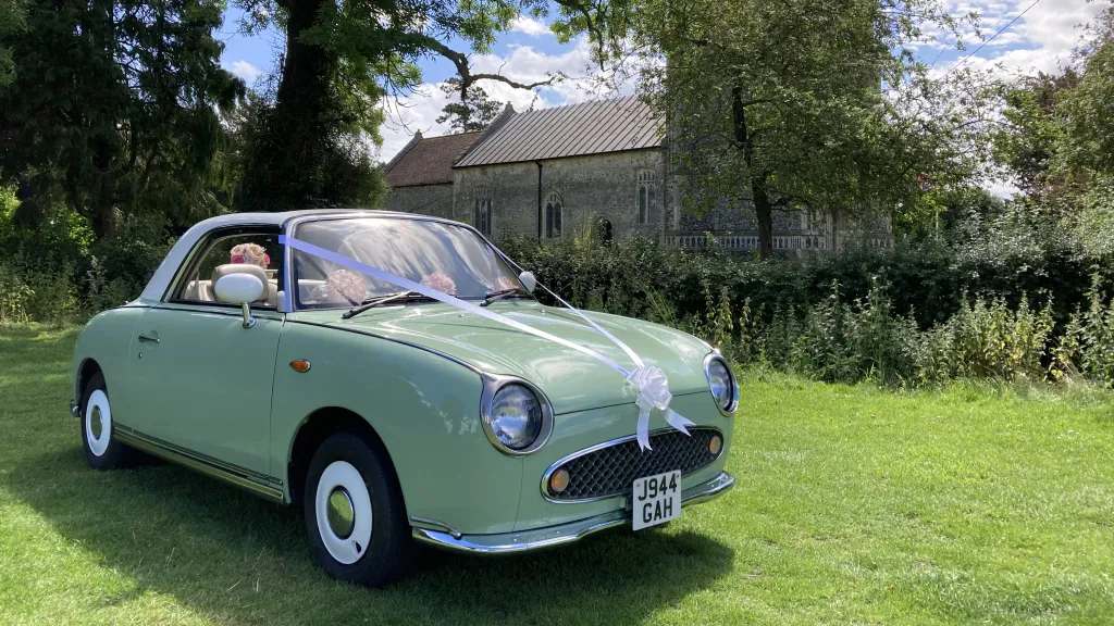 Classic Nissan Figaro in White And Pale Green with white ribbons