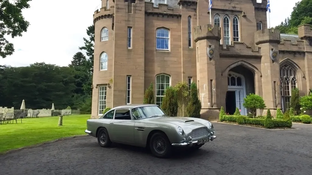 Classic Aston Martin DB5 in front of wedding venue