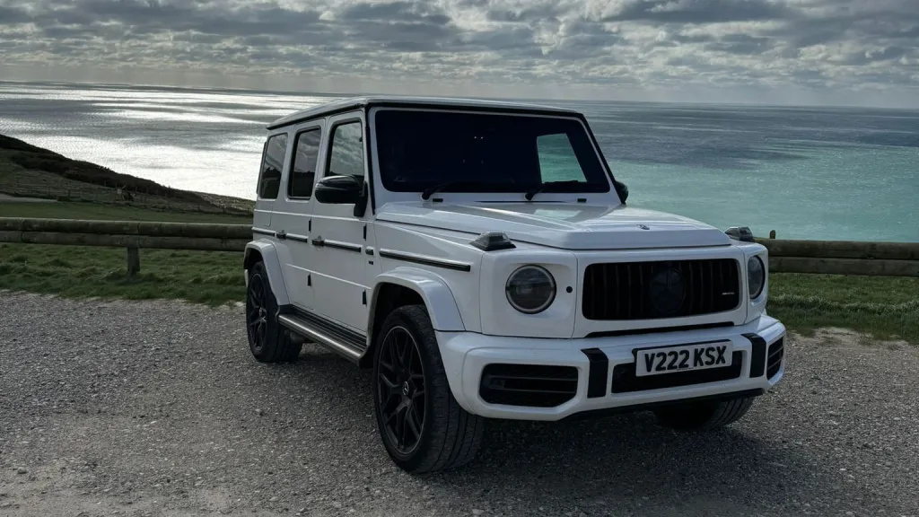 White Mercedes G-wagon on top of a cliff by the sea