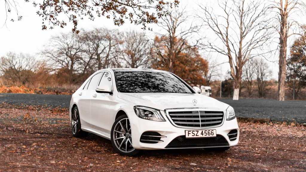 White Mercedes in Park with Autumn Background
