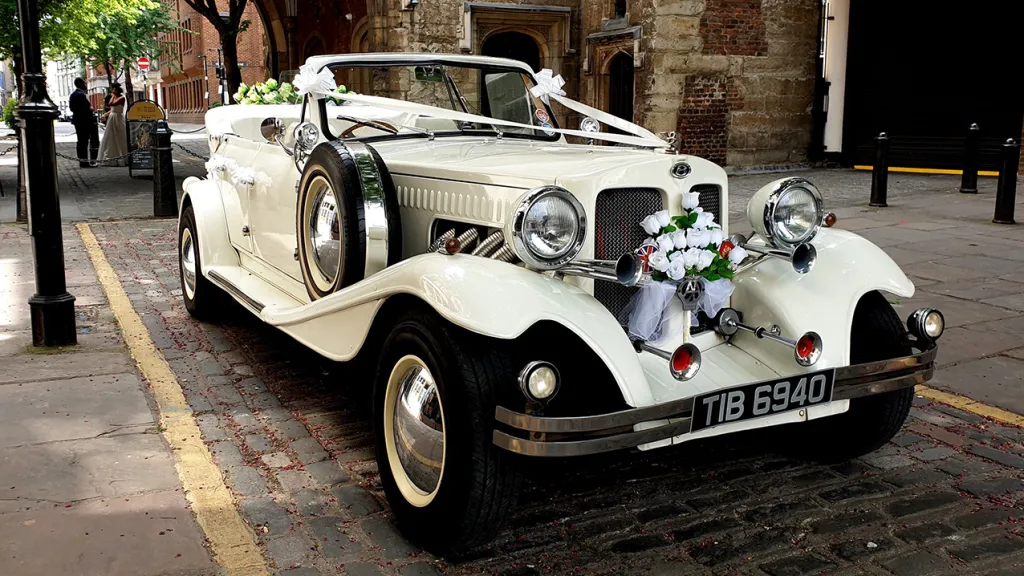 Beauford Convertible with Roof down. Bride ad Groom seen in background