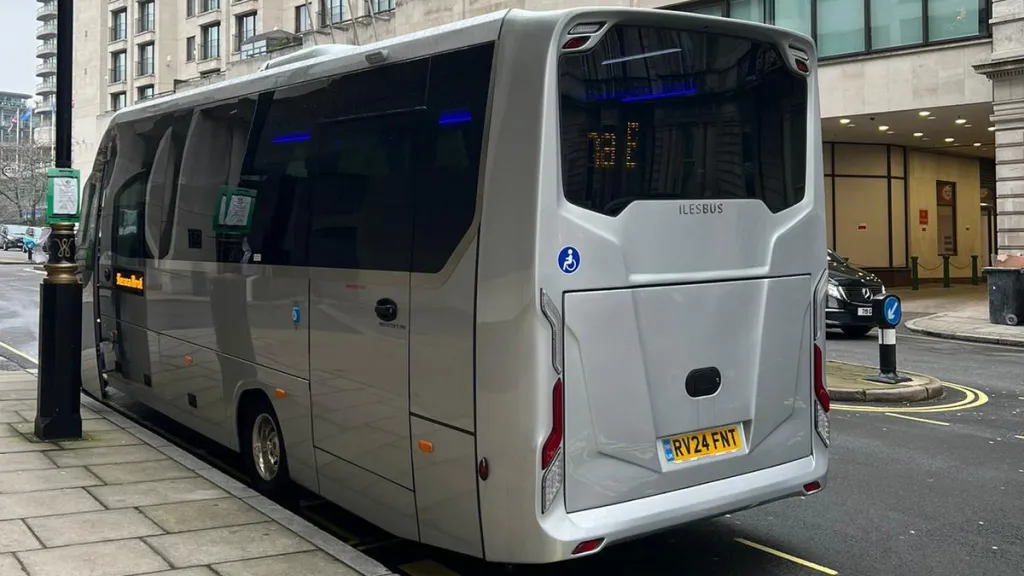 Rear Side view of Silver Modern 34-seat coach in London