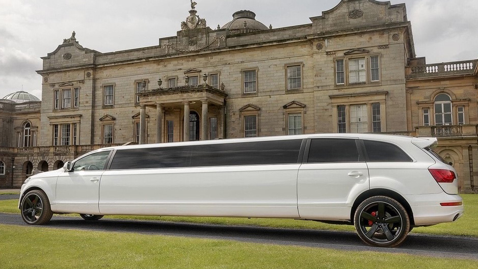 Rear Side view of Audi Limousine in front of venue. Vehicles has black alloy wheels and blacked out windows