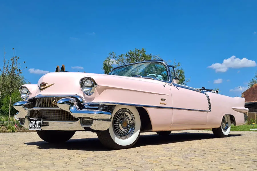 Classic American Pink Cadillac showing front chrome bumper.