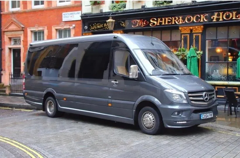 Side View of a Silver Grey 19-seater Mercedes Sprinter Mini Bus in front of wedding venue