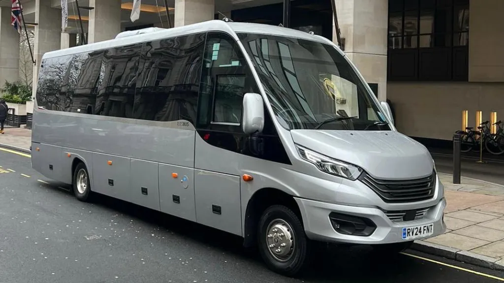 Front Side view of Silver Modern 34-seat coach in street of London