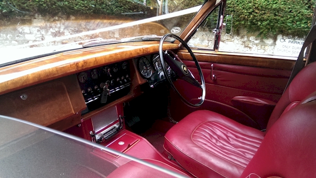 Front seat area shwoing the Cherry Red Leather and wooden dashboard