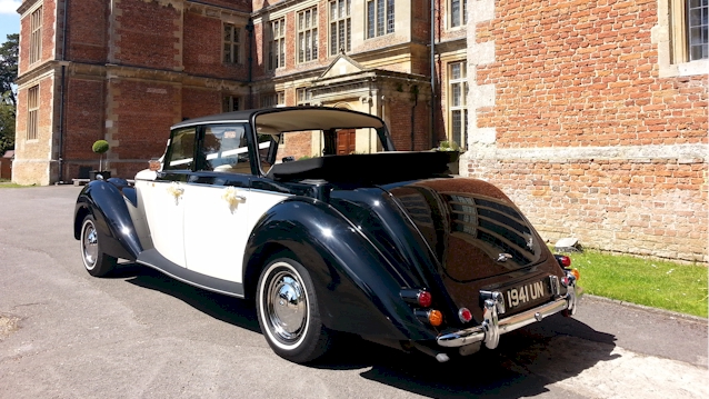 Rear view of Black & White Vintage Royale Convertible with Black Soft Top Open