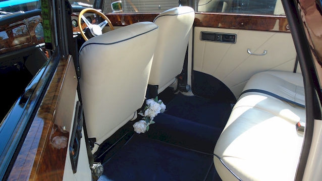 Rear interior seating area of Convertible Royale ;whowing Royale Blue Carpet and Cream Leather Seat with plenty of leg room
