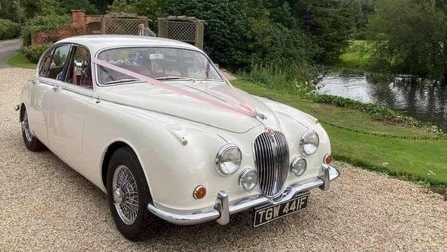 Front Side view of an Ivory Classic Mk2 Jaguar in a park in Berkshire with a lake in background