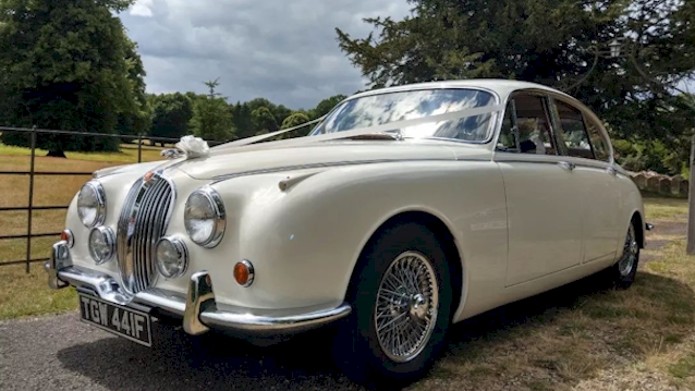 Front Left Side View of White Mk2 Jaguar dressed with White Ribbons accross its bonnet and spokes alloy wheels