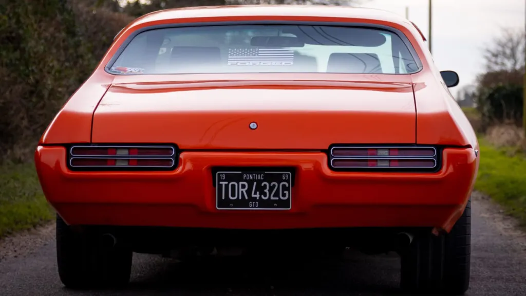 Full rear view of an Orange Classic Pontiac GTO