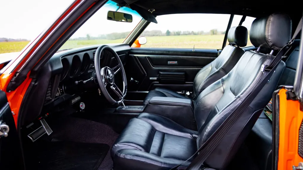 Interior front passenger view with black leather interior seats
