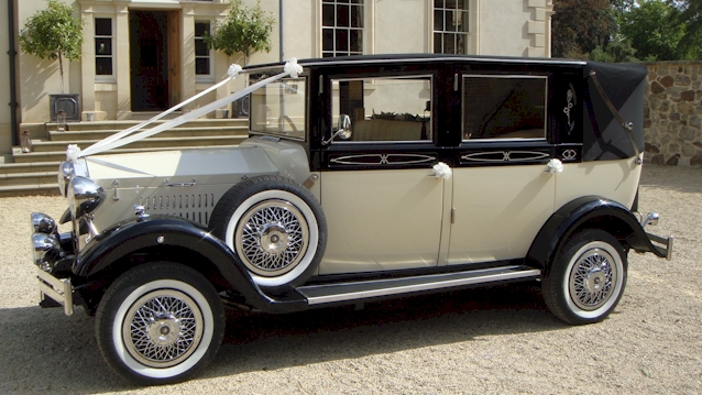 Left side view of imperial wedding car with black roof up and spare wheel mounted on black wheel arches