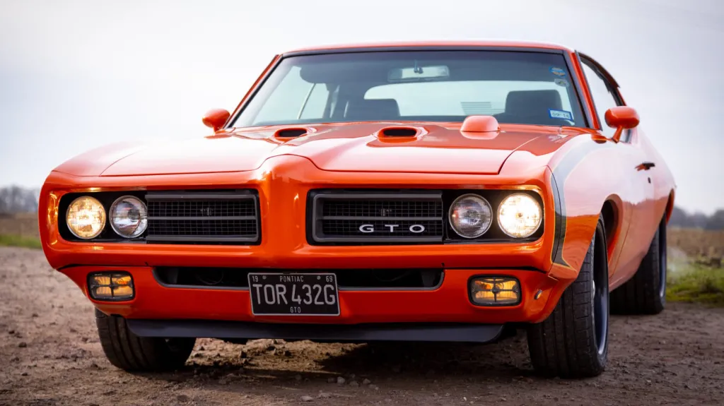 Side front View of Pontiac GTO with headlights on