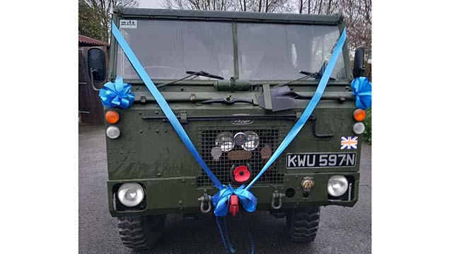 Full front view of Army Land Rover Vehicle deocrated with Blue Wedding Ribbons