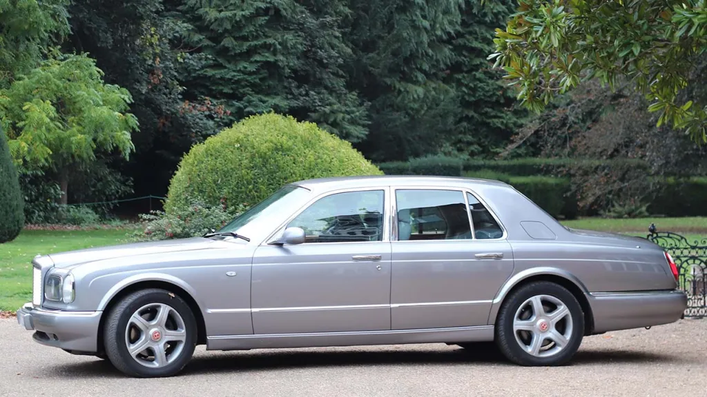 Left side view of Silver Bentley Arnage in a Park with Green Trees and Bushes