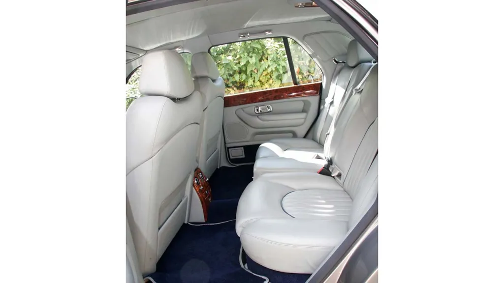 rear passenger seating area with crema leather interior and royale blue carpet with very spacious legroom