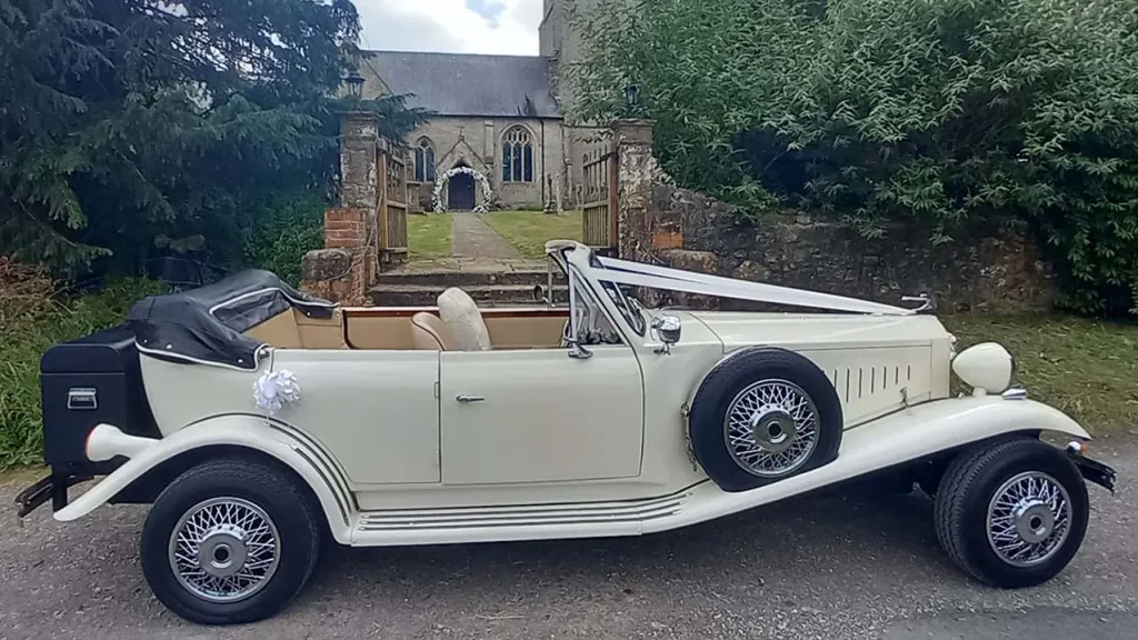 Right Side view of Ivory Beauford with Roof down, Spare wheel mounted on right wheel arch and Traditional V-shape white ribbon accross the bonnet