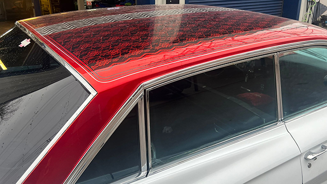 Aerial View of Red Custom Roof  on a Classic White Cadillac