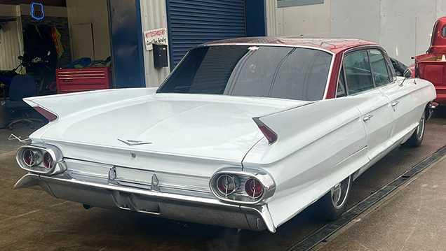 Rear view of White Cadillac showing the fin high tails