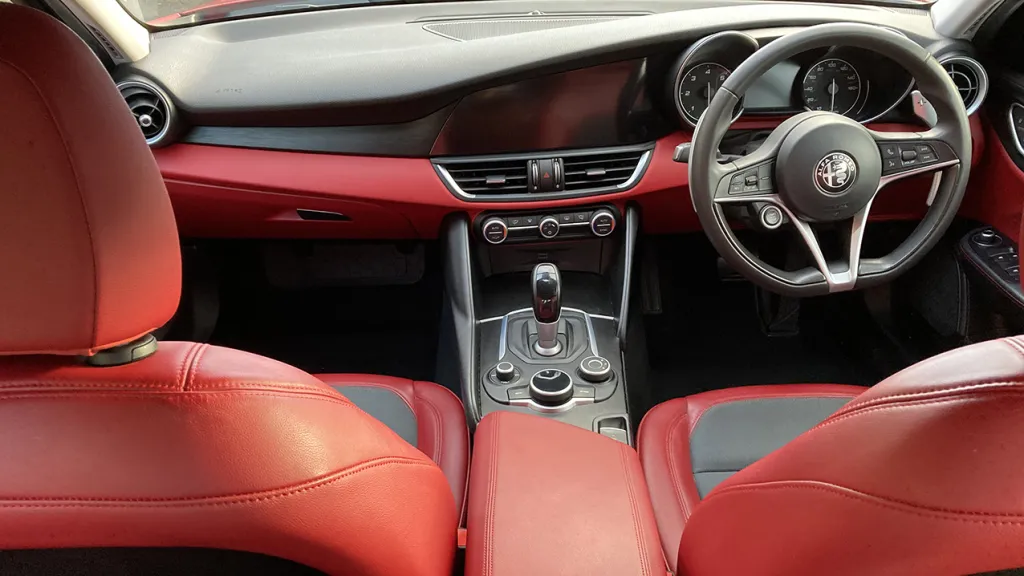Front Dashboard view in a Modern and Sporty Alfa Romeo Giulia with matching Black and Red Colours
