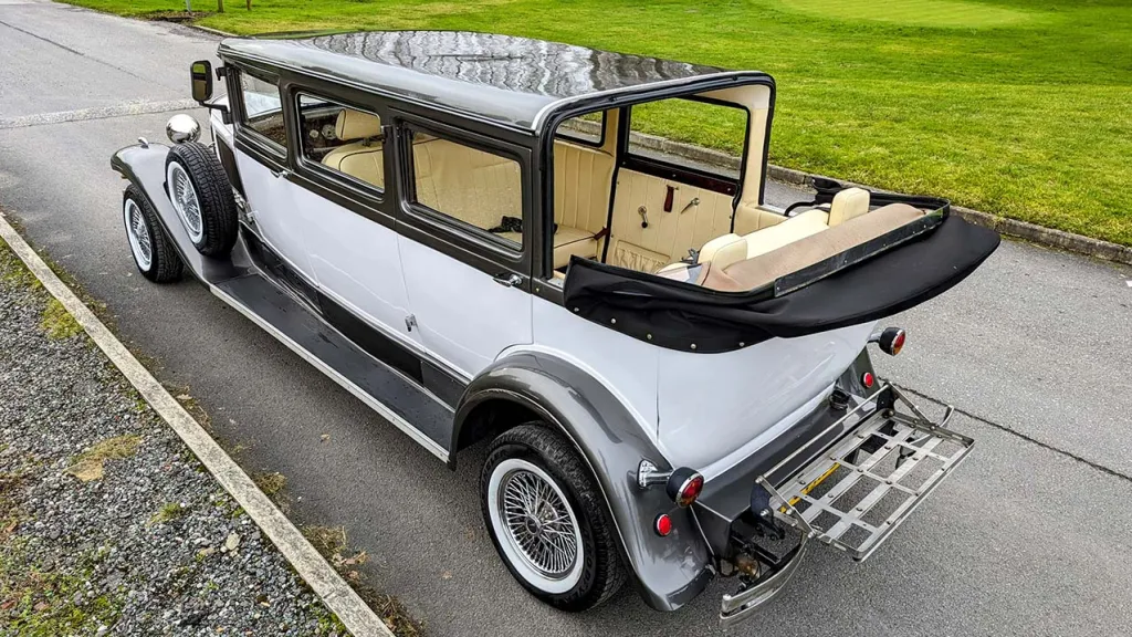 Aerial view of the Bramwith Limousine with roof open and door close showing the cream leather interior and Bronze roof