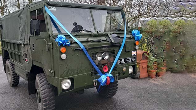 Front side view of a Army Khaki green decorated with royale Blue ribbons