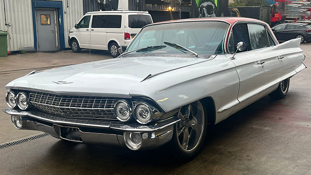 Front view of White Cadillac with large Chrome bumper