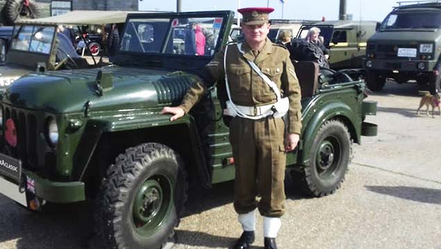 Chaufeur in a Ceremonial Period uniform in front of Army Green Classic austin Champ