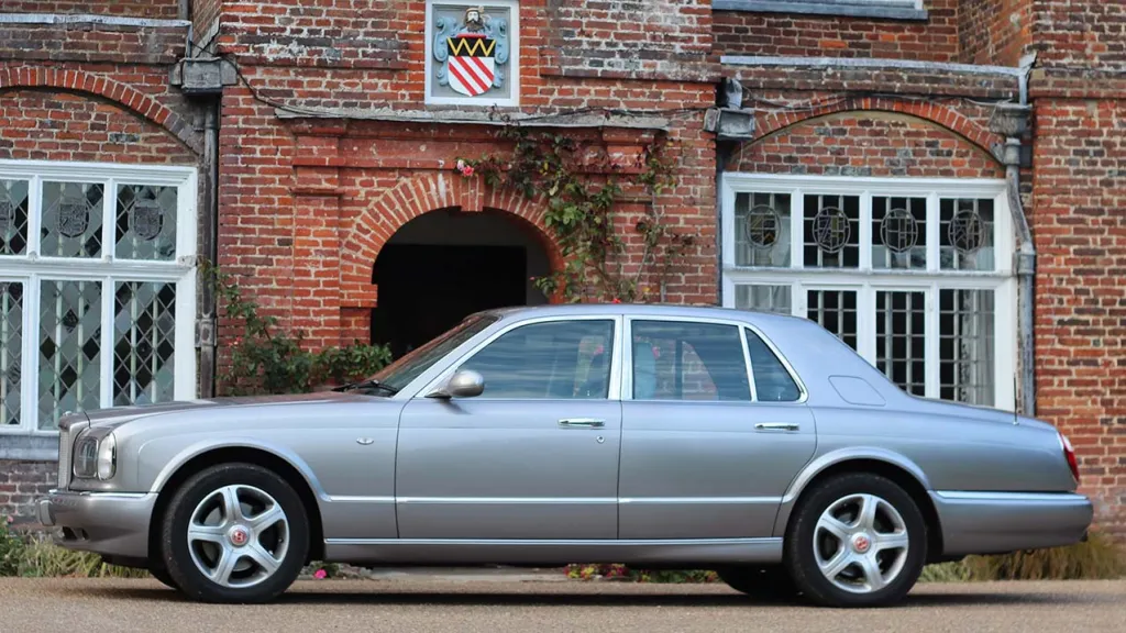 Left side view of Silver Bentley Arnage in front of wedding venue