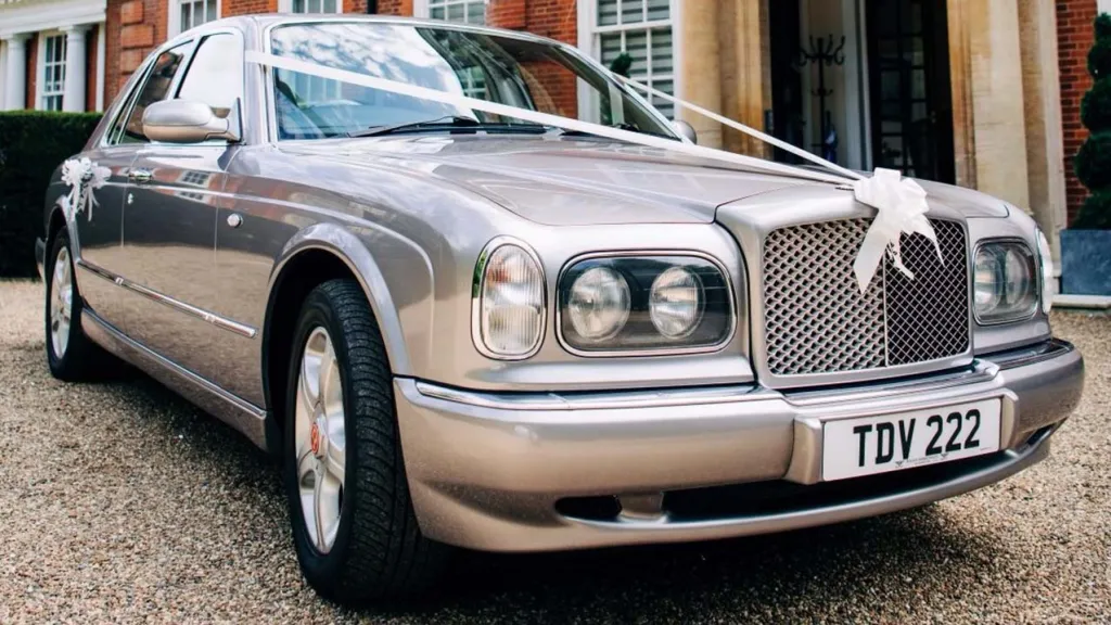 Front Side view of Modern Silver Bentley Arnage with White ribbons