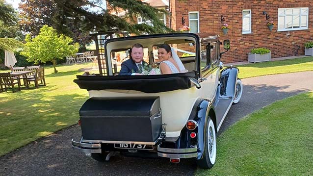 Rear view of Bramwith Convertible with Roof down and Newly Wed Couple looking back