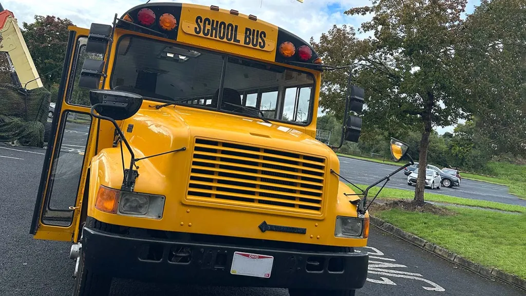 Yellow american school bus waiting on the road for passengers