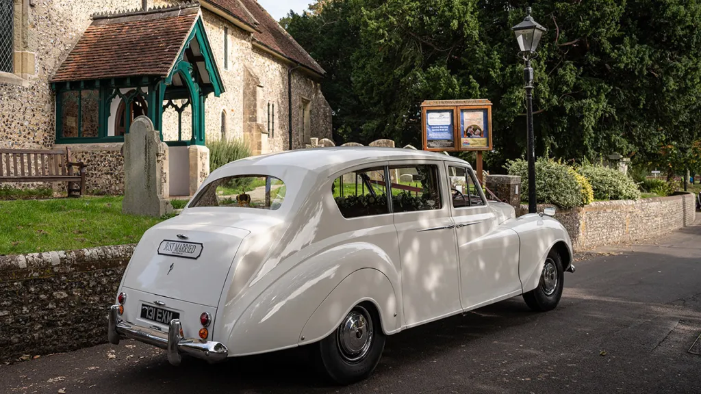 Rear side view of Austin princess in front of church