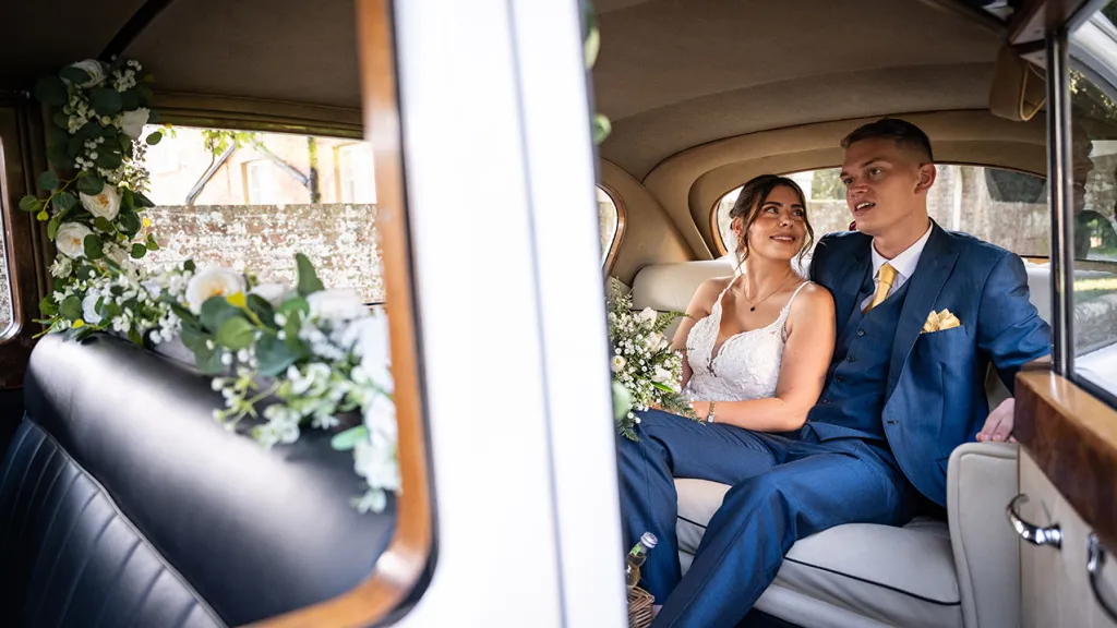 Bride and Groom seating inside the classic austin limousine