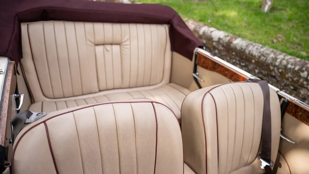 Rear crema leather bench seat inside Beauford car