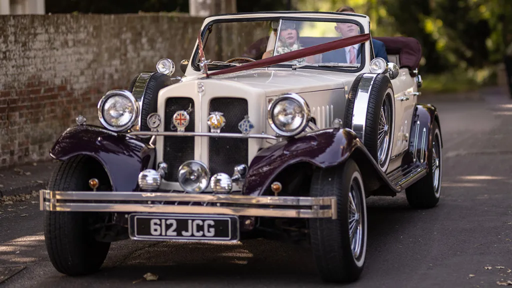 Full front view of Ivory Beauford with Burgundy V-Shape Ribbons accross its front bonnet