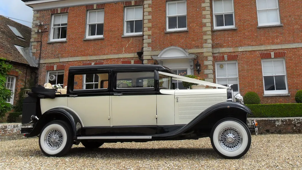 Right Side view of Branford car decorated with traditional white wedding ribbons and roof is open