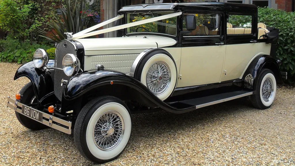 Black & Ivory Vintage car dressed with white ribbons  and convertible roof open