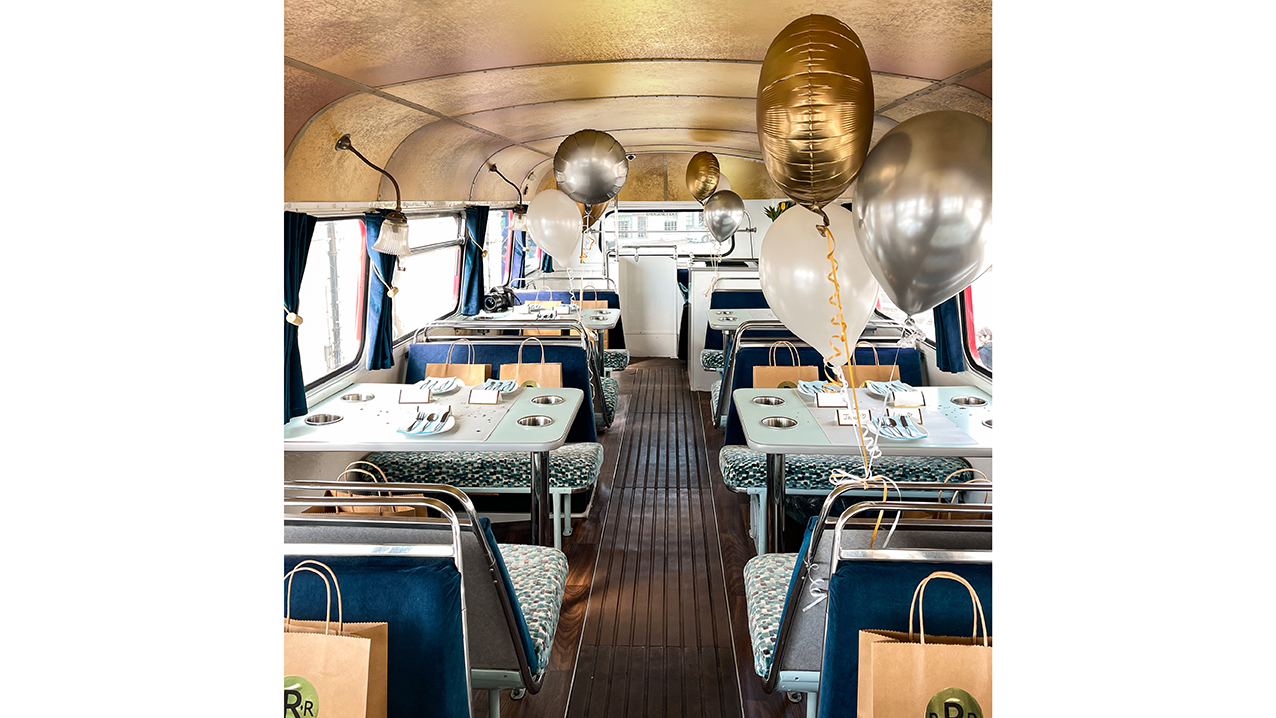 interior view of the upper deck decorated with white and gold balloons.