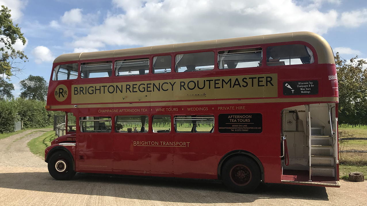 Left side view of red routemaster bus showing the rear open platform