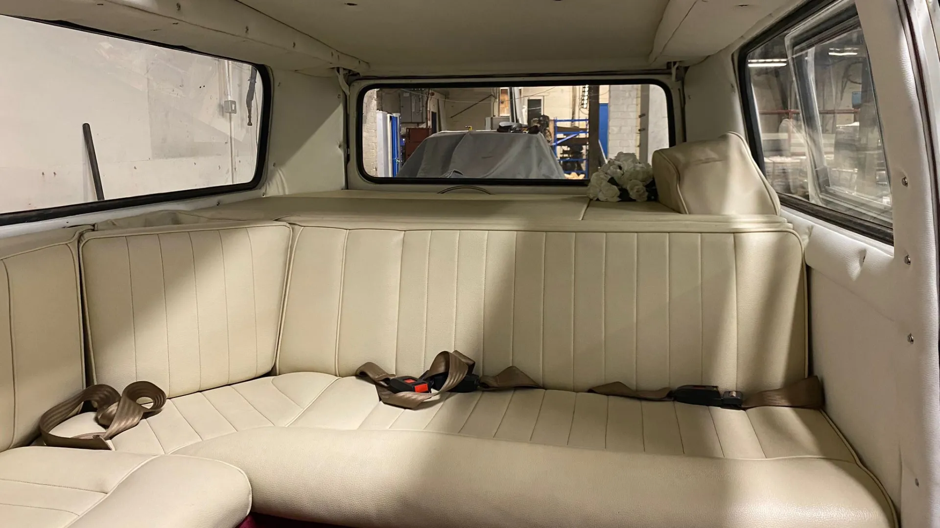 interior view of cream leather interior L-shape bench seat.