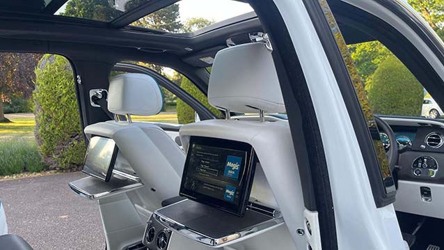 interior view of Rolls-Royce Cullinan showing the entertainment system and large panoramic sunroof