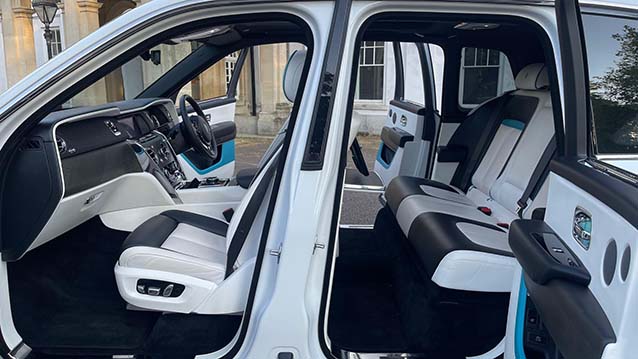 side view with both doors open showing the white leather interior in Rolls-Royce cullinan