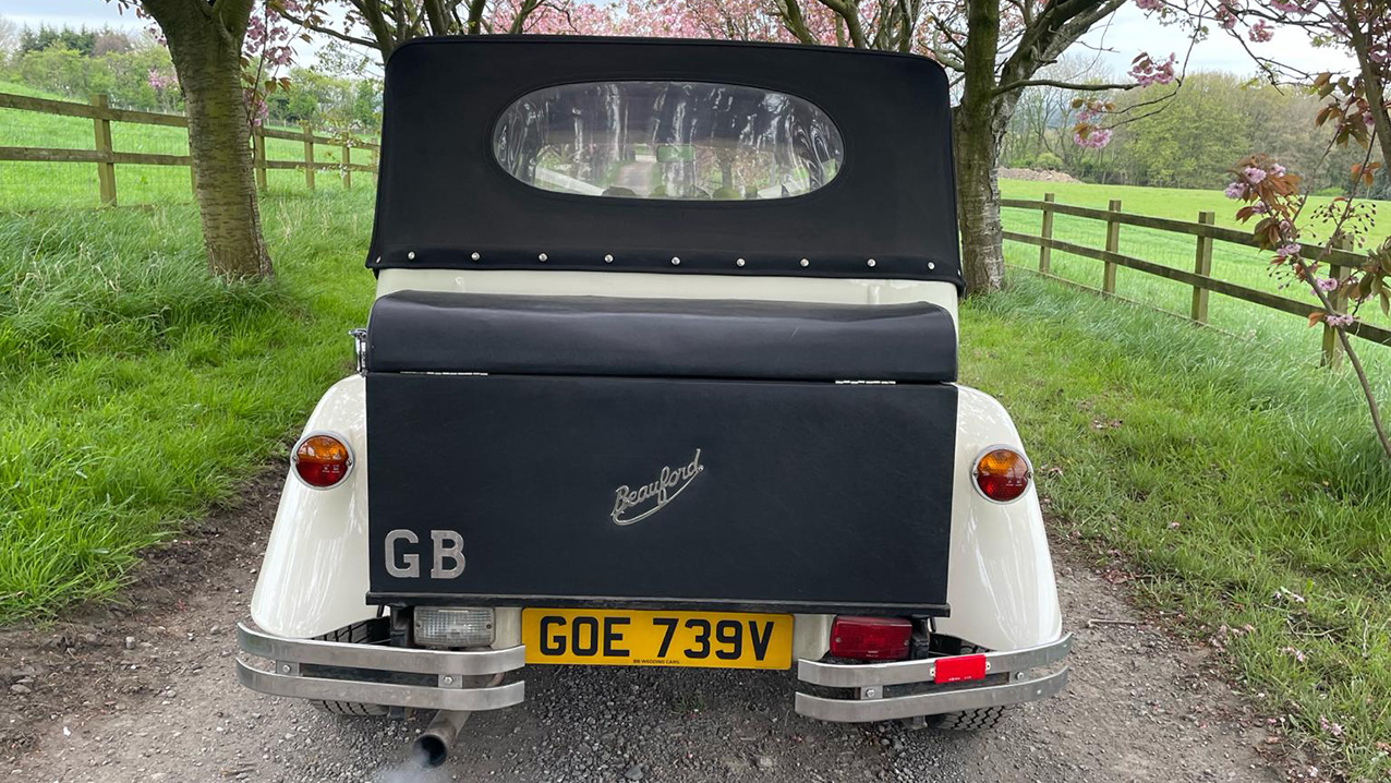 Rear view of Beauford Convertible showing the window in the soft Roof top and black Picnic trunk