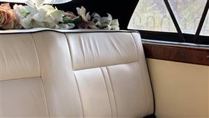 interior of the Beauford Car with Cream Leather interior and flowers on the parcel shelf.