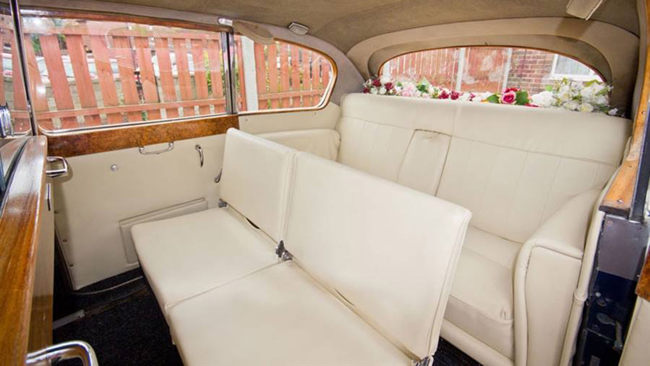 interior view of Austin Princess rear cabin with cream leather interior and casual seats up.